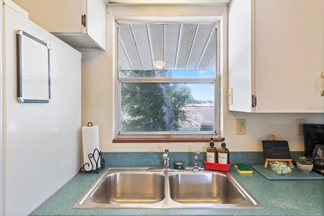 kitchen with sink and white cabinetry