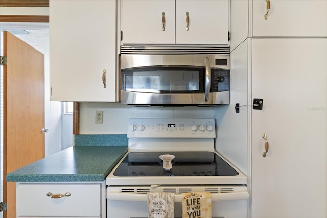 kitchen with white range with electric cooktop and white cabinets