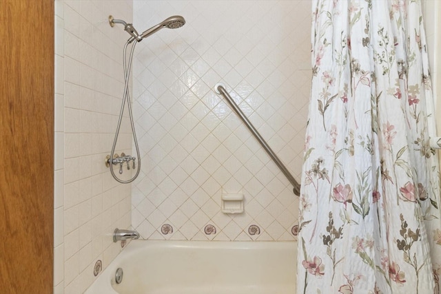 bathroom with shower / bath combo with shower curtain