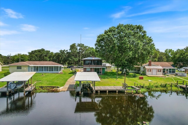 view of dock featuring a lawn and a water view