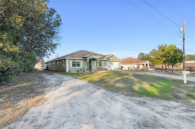 ranch-style house featuring a front lawn and a garage