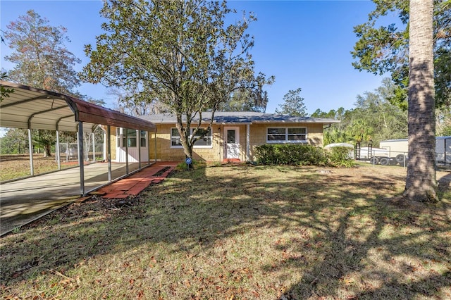 view of front facade with a carport and a front lawn