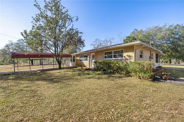 view of front of property with a carport and a front yard