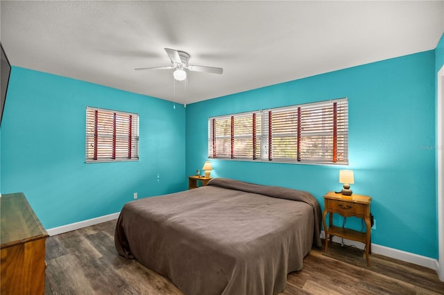 bedroom with dark wood-type flooring and ceiling fan