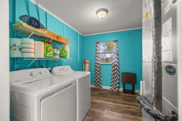 laundry room featuring washing machine and dryer, ornamental molding, a textured ceiling, and dark hardwood / wood-style flooring