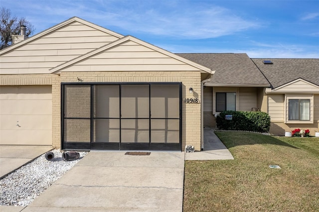 ranch-style home featuring a garage and a front yard