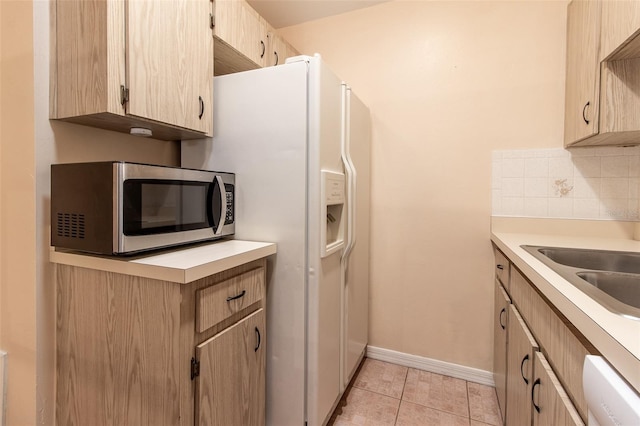 10918 SE 50th Ave, Belleview, FL 34420 - kitchen with dishwasher, light brown cabinets, decorative backsplash, sink, and light tile patterned floors