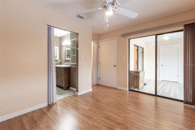 10918 SE 50th Ave, Belleview, FL 34420 - interior space featuring ceiling fan, light wood-type flooring, sink, and a textured ceiling