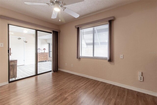 10918 SE 50th Ave, Belleview, FL 34420 - spare room featuring a textured ceiling, ceiling fan, and hardwood / wood-style flooring