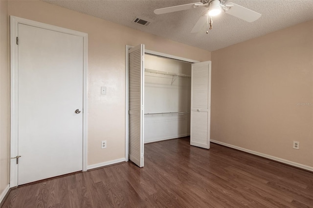 10918 SE 50th Ave, Belleview, FL 34420 - unfurnished bedroom with ceiling fan, a closet, dark hardwood / wood-style flooring, and a textured ceiling