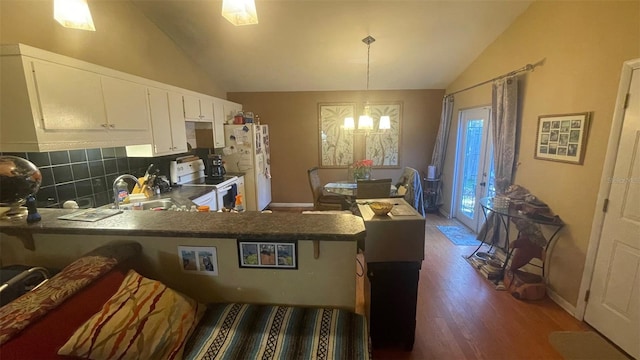 kitchen with sink, white cabinets, kitchen peninsula, and white appliances