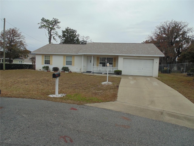 ranch-style house with a front lawn, a garage, and a porch