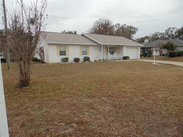 single story home with a front lawn, covered porch, and a garage