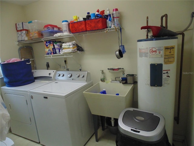 clothes washing area featuring sink, electric water heater, and washing machine and clothes dryer