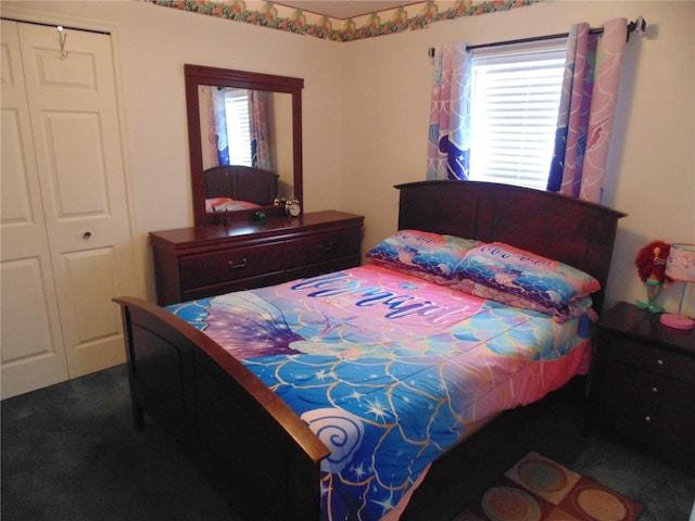 bedroom with a closet, dark carpet, and multiple windows