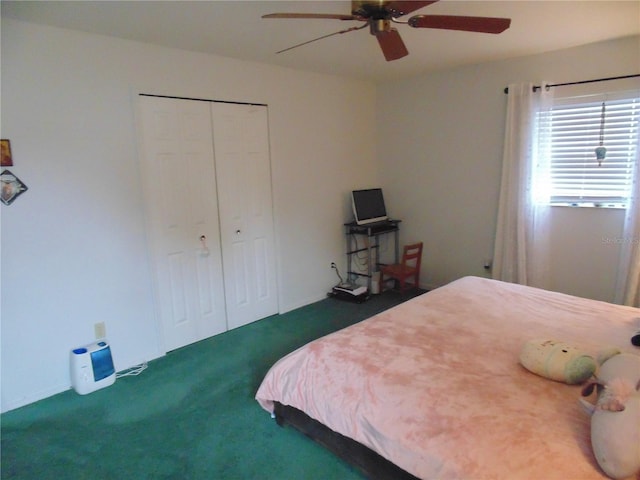 bedroom with dark colored carpet, a closet, and ceiling fan