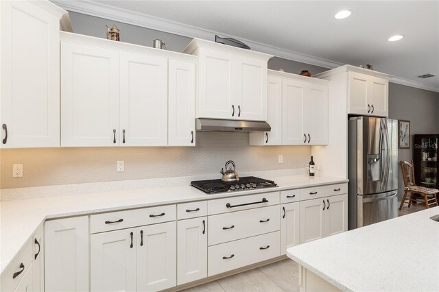 kitchen with white cabinetry, appliances with stainless steel finishes, decorative backsplash, light tile patterned flooring, and crown molding