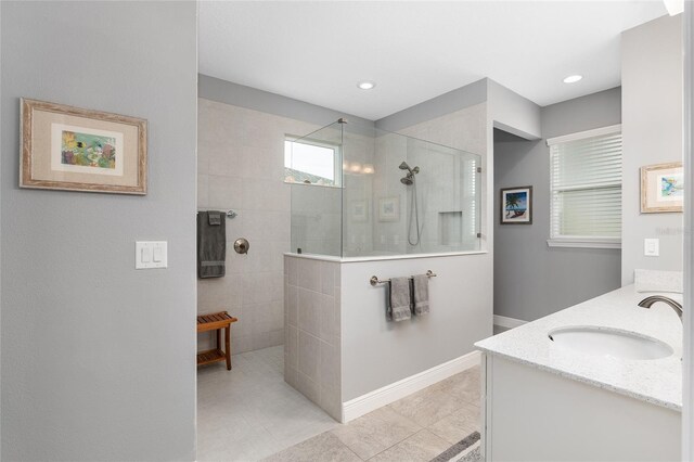 bathroom with vanity, tile patterned floors, and a tile shower