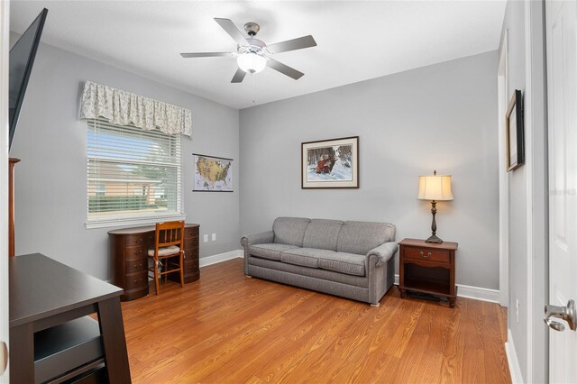 living room with ceiling fan and light hardwood / wood-style floors