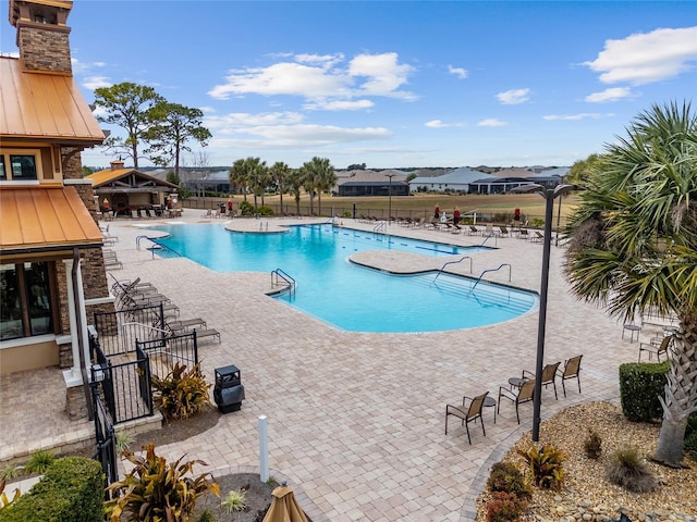 view of swimming pool with a patio