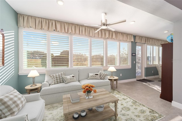 carpeted living room with ceiling fan