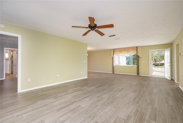 unfurnished living room featuring ceiling fan and light wood-type flooring