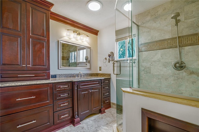 bathroom with vanity and tiled shower