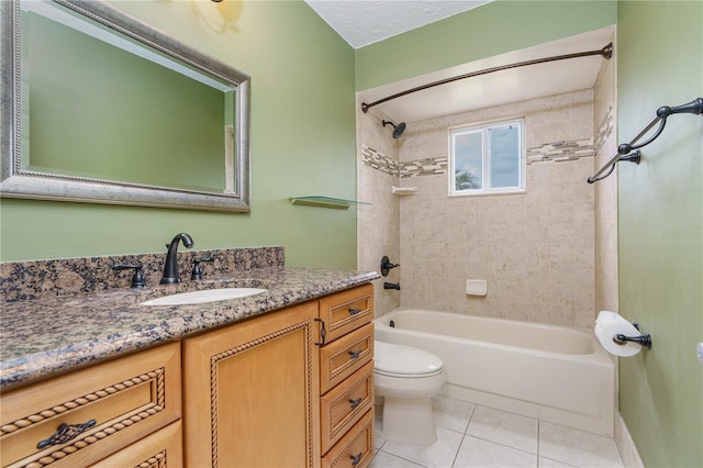 full bathroom featuring toilet, tiled shower / bath combo, tile patterned floors, and vanity