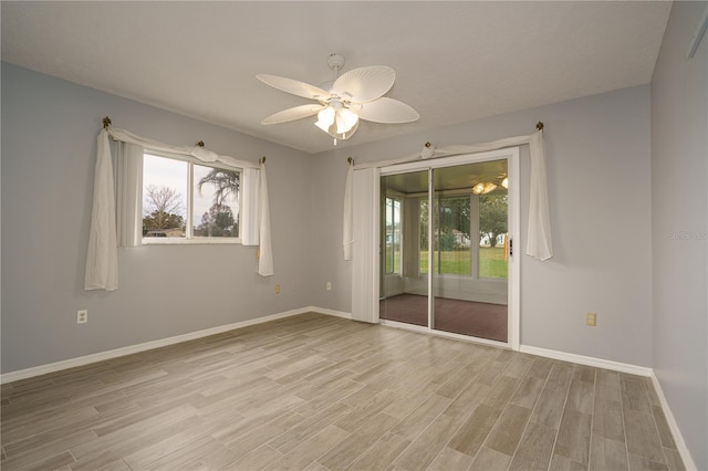 spare room with ceiling fan and light wood-type flooring