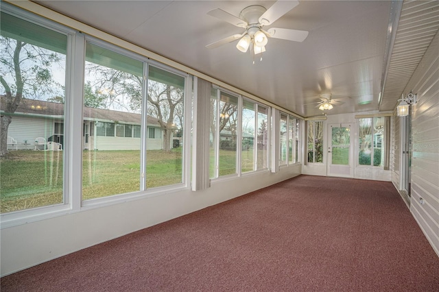 unfurnished sunroom featuring ceiling fan