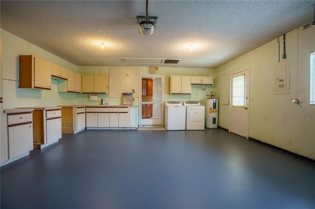 garage with sink, washing machine and dryer, a garage door opener, and water heater