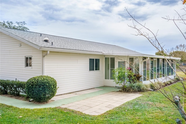 back of house with a sunroom, a yard, and a patio