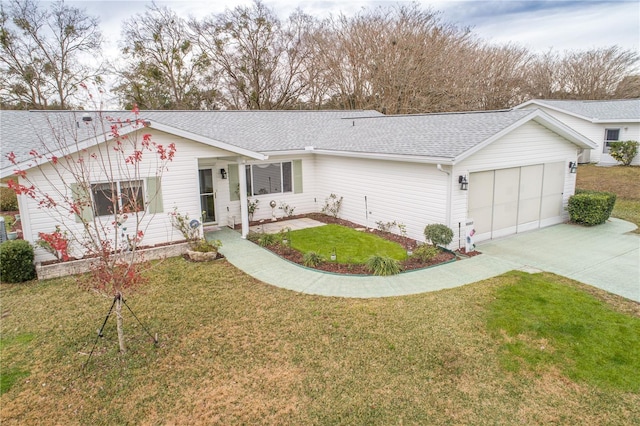 view of front of property with a garage and a front lawn