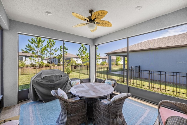 sunroom featuring ceiling fan