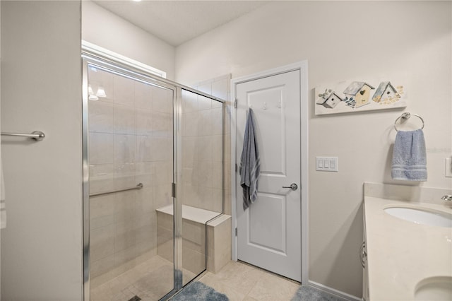 bathroom featuring vanity, tile patterned floors, and an enclosed shower