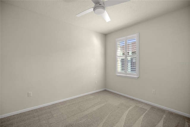 carpeted empty room featuring a textured ceiling and ceiling fan