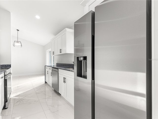 kitchen with white cabinetry, appliances with stainless steel finishes, lofted ceiling, and hanging light fixtures