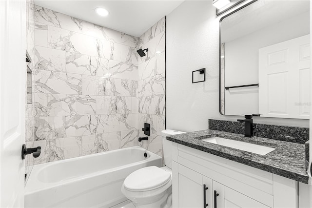 full bathroom featuring toilet, vanity, and tiled shower / bath