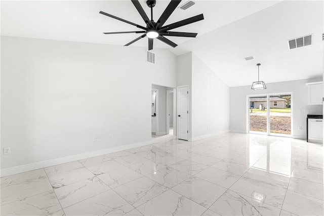 unfurnished living room with ceiling fan and lofted ceiling