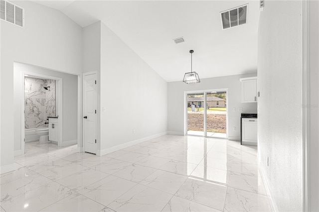 unfurnished living room featuring lofted ceiling