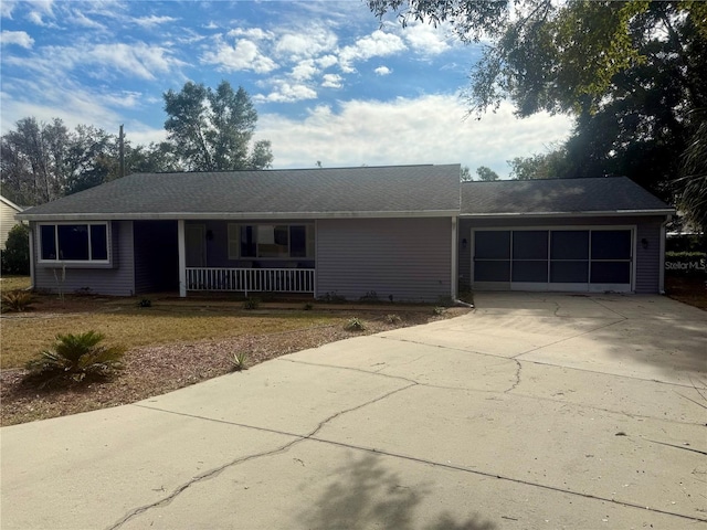 ranch-style house with concrete driveway, a porch, and an attached garage