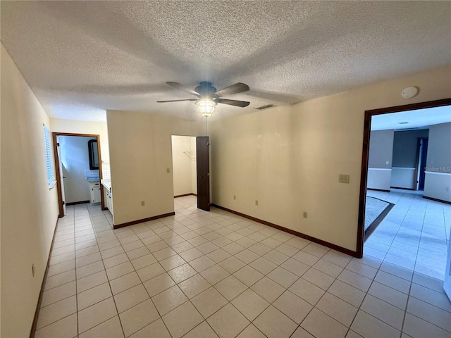 unfurnished room featuring a ceiling fan, a textured ceiling, and light tile patterned floors