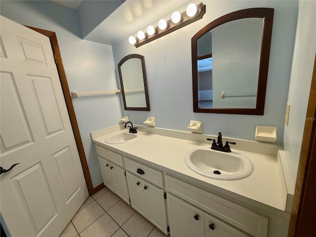 full bathroom featuring double vanity, a sink, and tile patterned floors