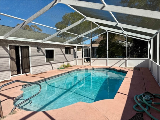 outdoor pool with glass enclosure and a patio area