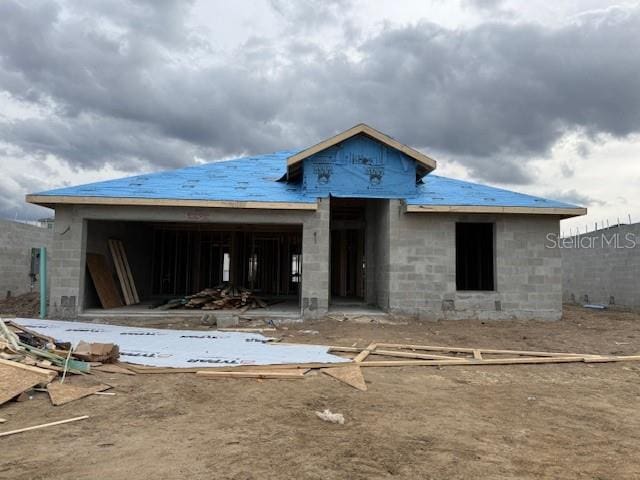 rear view of property featuring concrete block siding