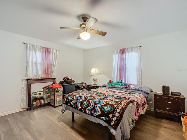 bedroom with ceiling fan and hardwood / wood-style floors