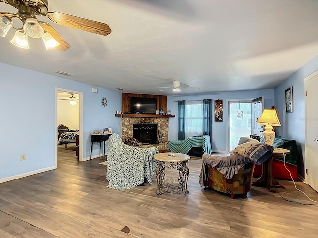 living room featuring ceiling fan and hardwood / wood-style floors