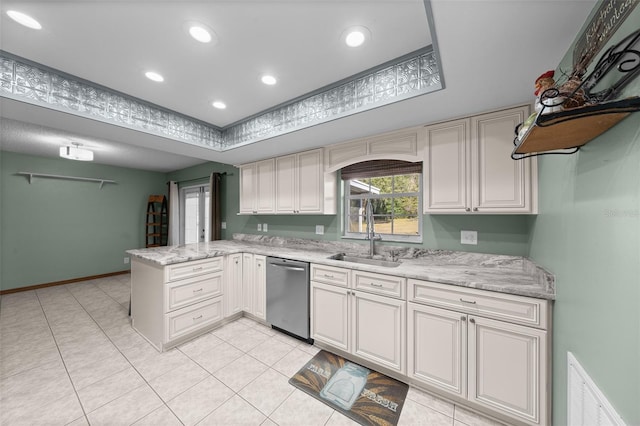 kitchen with stainless steel dishwasher, kitchen peninsula, sink, and light stone countertops