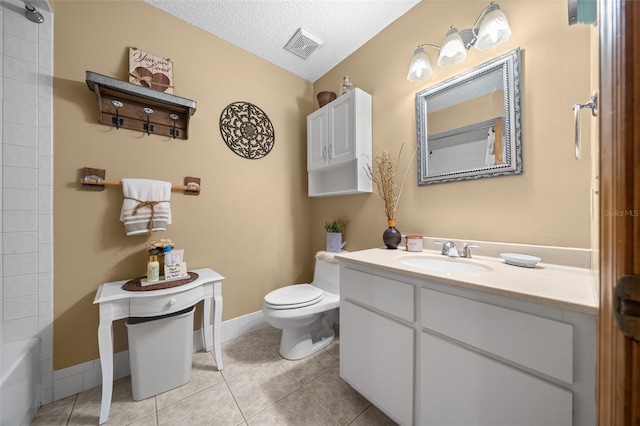 bathroom with vanity, tile patterned floors, a textured ceiling, and toilet