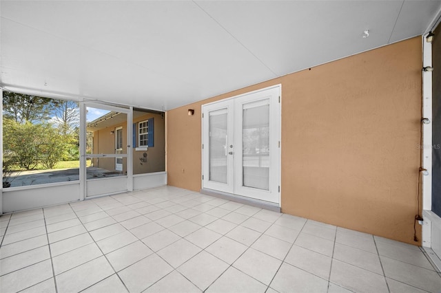 unfurnished sunroom featuring french doors